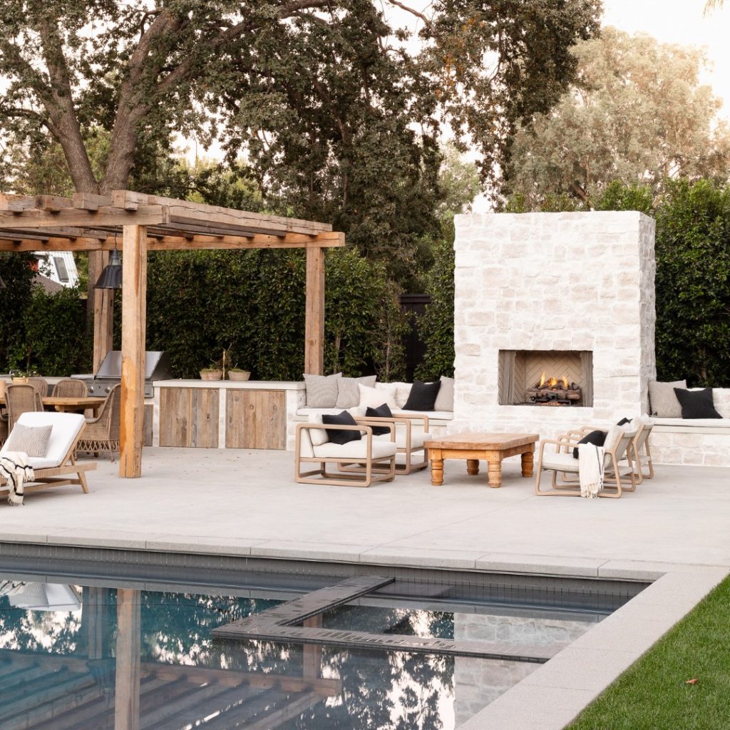 Outdoor pool and fireplace with stone