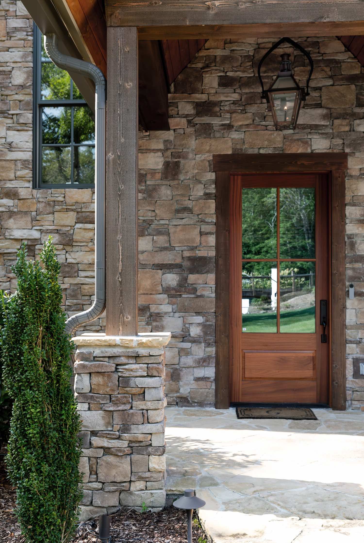  Close-up of stone veneer entry way with light gray stone and matching mortar