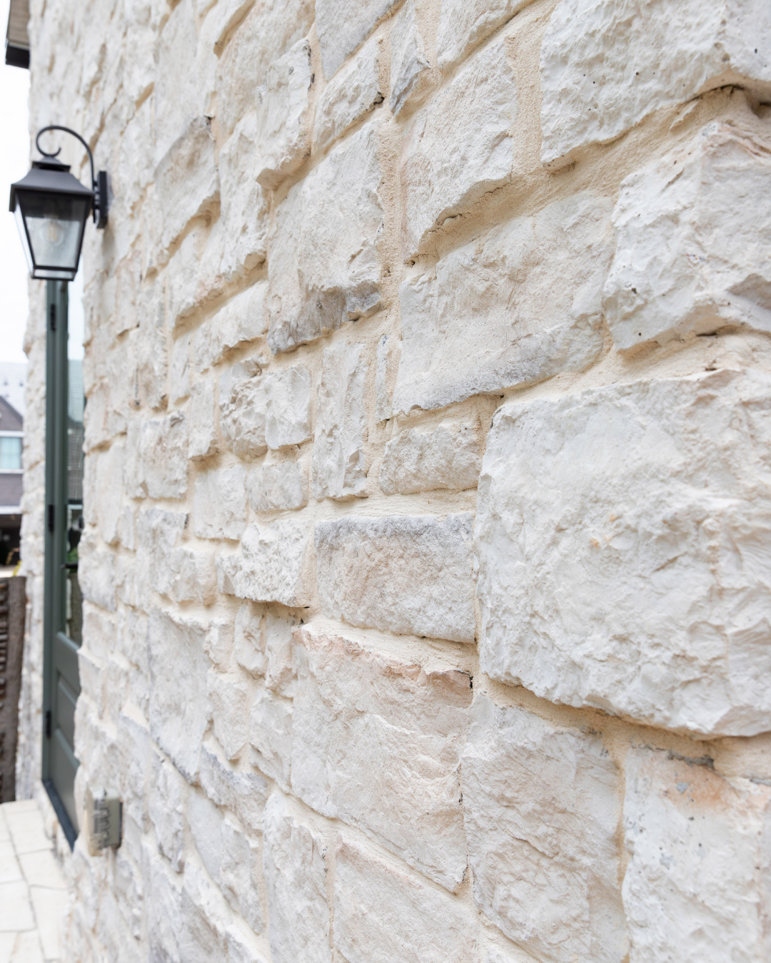 Exterior Home using light creamy white stone veneer