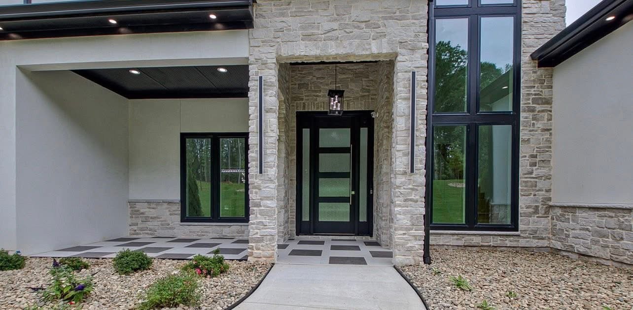 Handcrafted Hermitage stone veneer with Ivory Buff grout on a contemporary home exterior