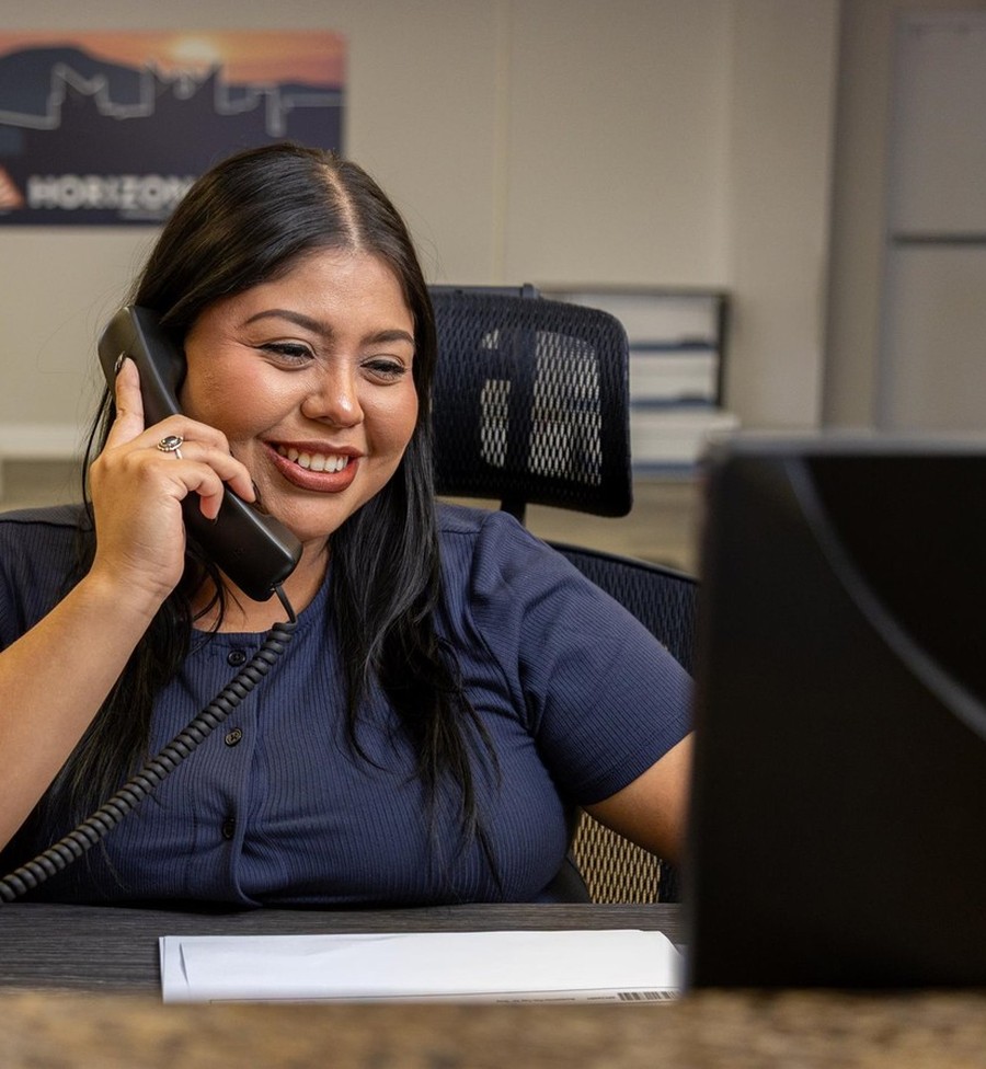 Mariana Alvarado on the phone with a customer
