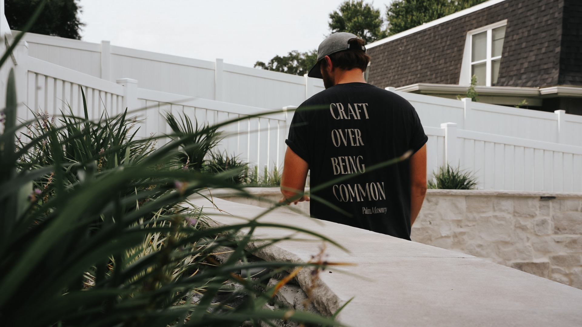 A Palm Masonry crew member on site, wearing a Craft Over Being Common shirt